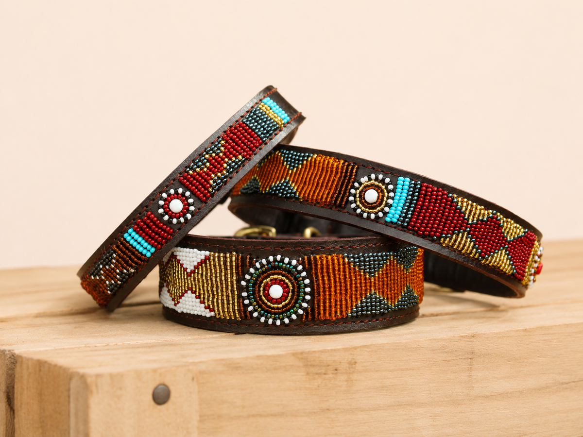 PAWNEE beaded leather dog collar with orange, red, turquoise and gold Maasai patterns on wooden crate